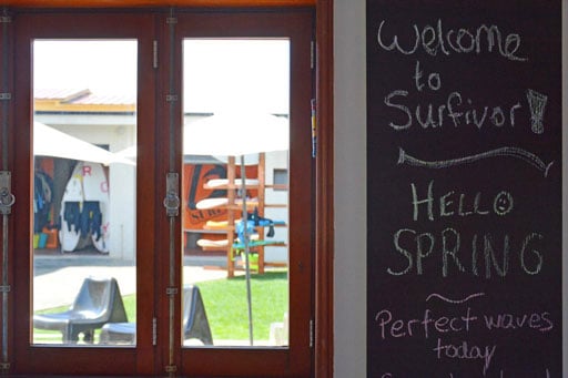 A view of the surfboards through the window of the surf camp in Portugal