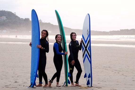 Happy surf students on the beach of San Vicente in Spain