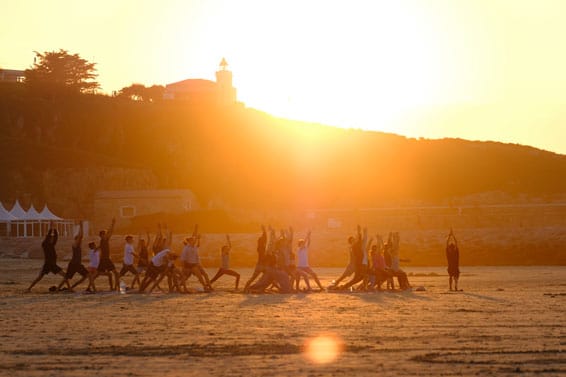 Sufficient yoga on the most beautiful beaches in Spain after the surf course with beautiful sunsets