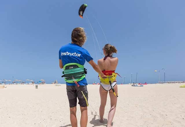 The kitesurfing instructor practices with a kitesurfing student at Flag Beach